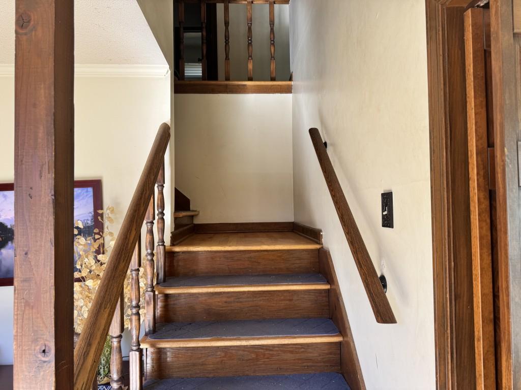 4703 Marc Court Southwest Lilburn, GA 30047 - Photo 25 of 57 a view of staircase with wooden floor and stairs
