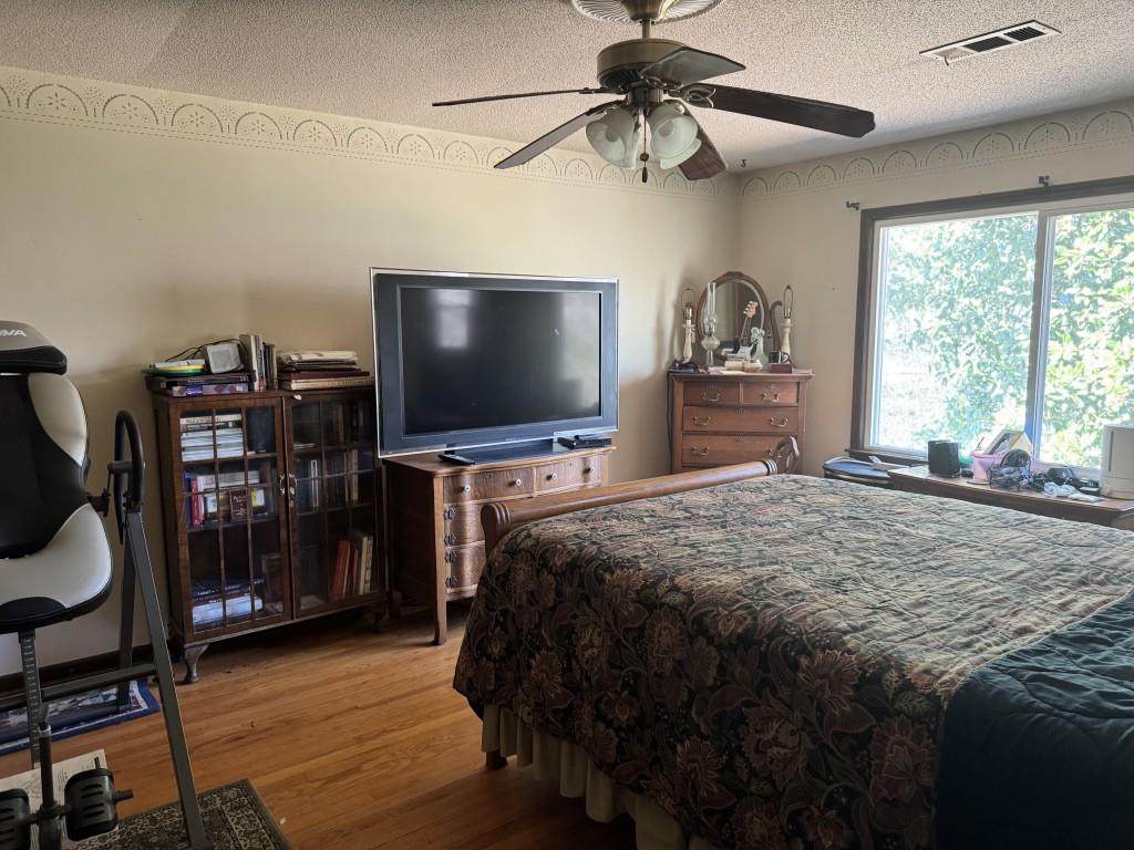 4703 Marc Court Southwest Lilburn, GA 30047 - Photo 28 of 57 a bedroom with a bed and a flat screen tv