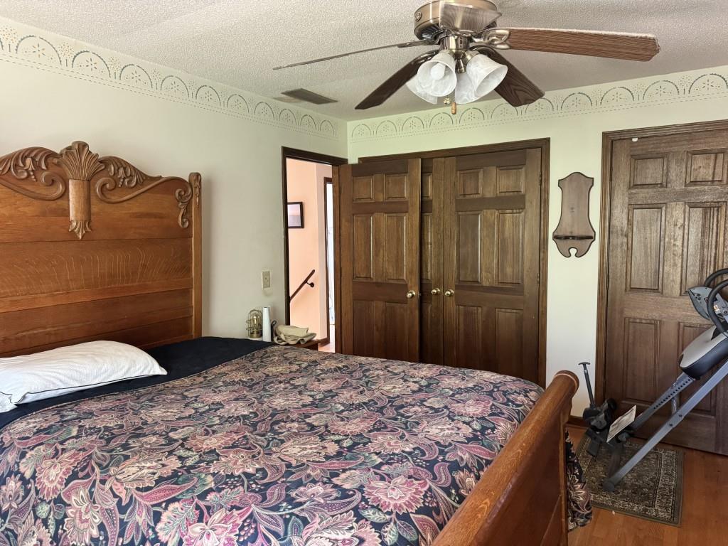 4703 Marc Court Southwest Lilburn, GA 30047 - Photo 29 of 57 a bedroom with a bed and a chandelier