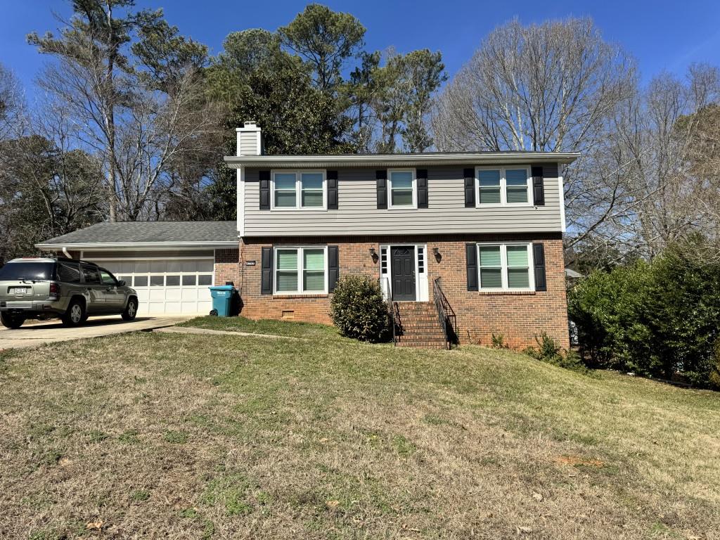 4703 Marc Court Southwest Lilburn, GA 30047 - Photo 3 of 57 a house view with a garden space