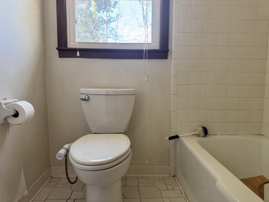 4703 Marc Court Southwest Lilburn, GA 30047 - Photo 37 of 57 a bathroom with a toilet and a bathtub