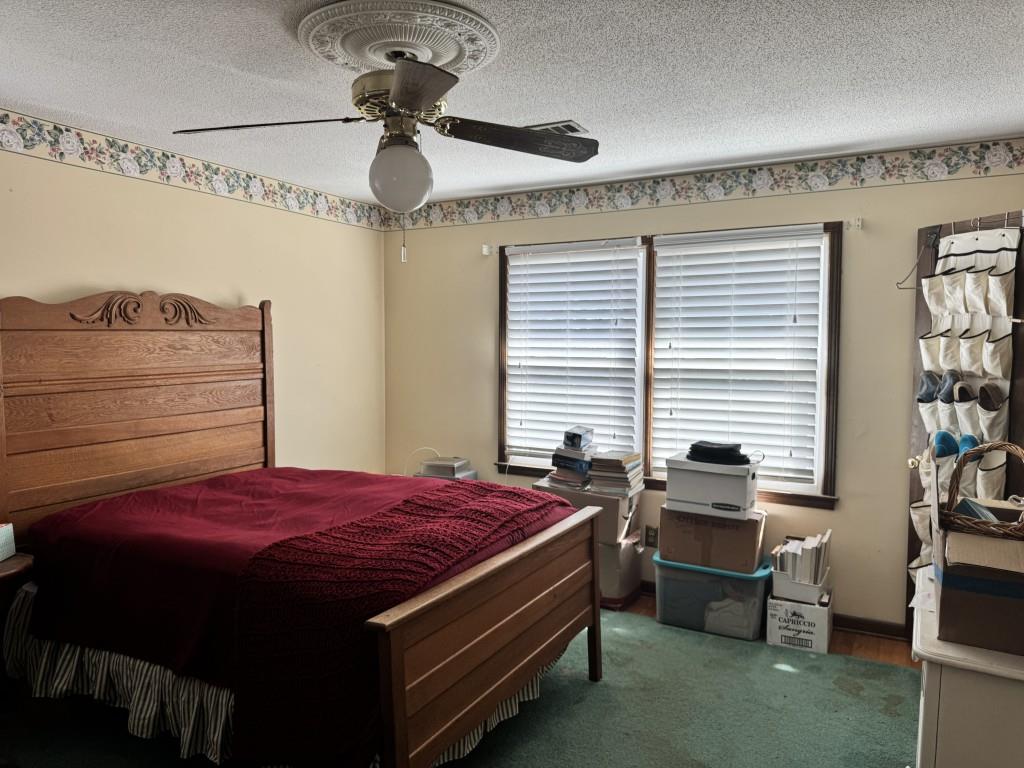 4703 Marc Court Southwest Lilburn, GA 30047 - Photo 40 of 57 a bed room with a bed and a chandelier