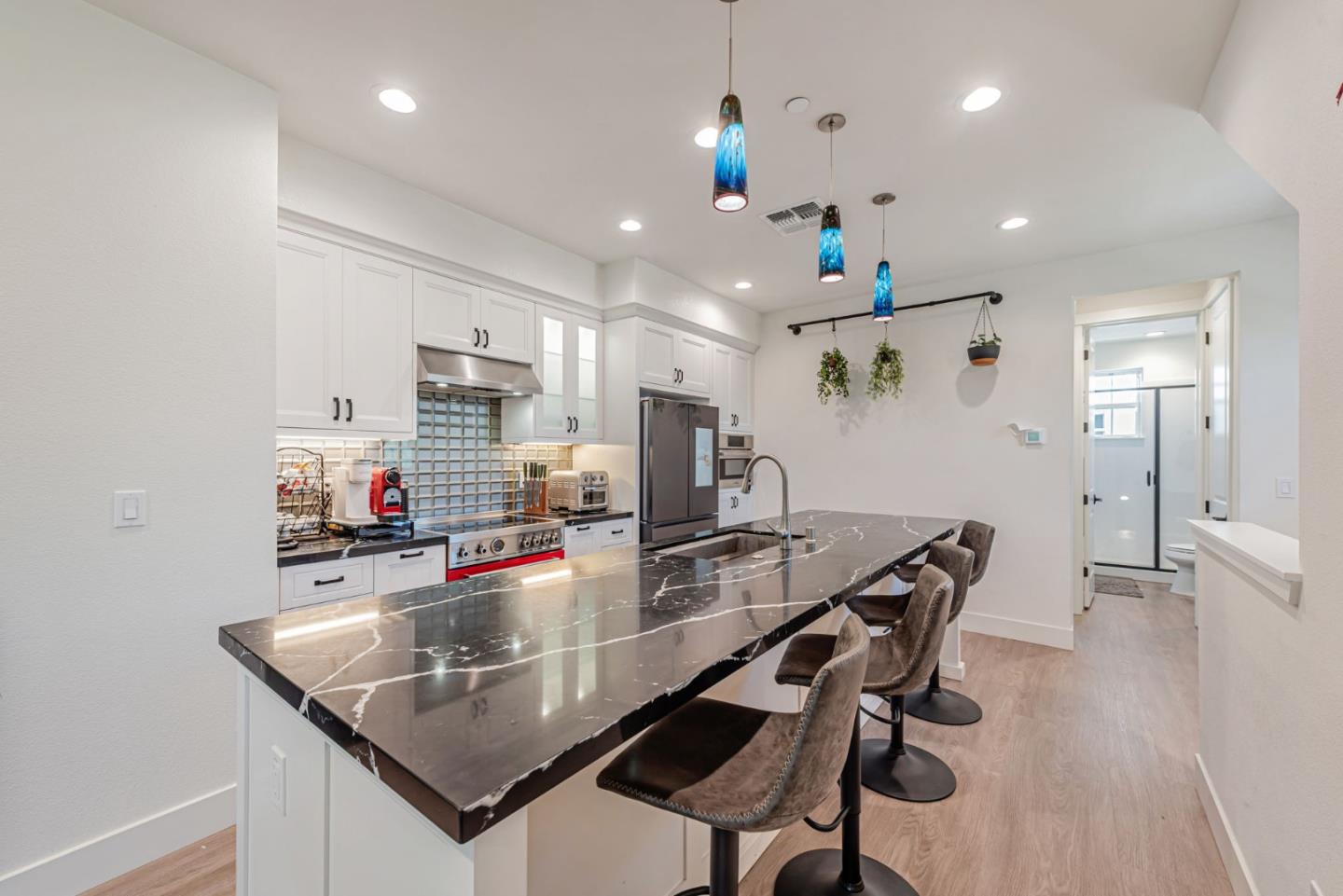 32 Seda Lane Morgan Hill, CA 95037 - Photo 13 of 37 a kitchen with stainless steel appliances kitchen island granite countertop a stove a refrigerator a sink a dining table and chairs with wooden floor