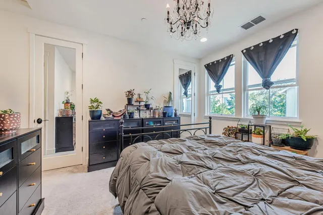 a bedroom with a large bed and a window