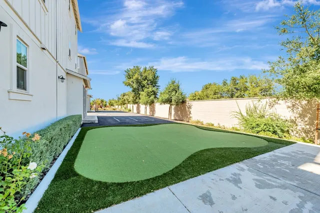 a view of a house with swimming pool and sitting area