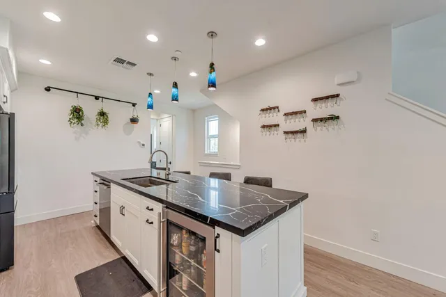 a kitchen with kitchen island a sink appliances and a counter top