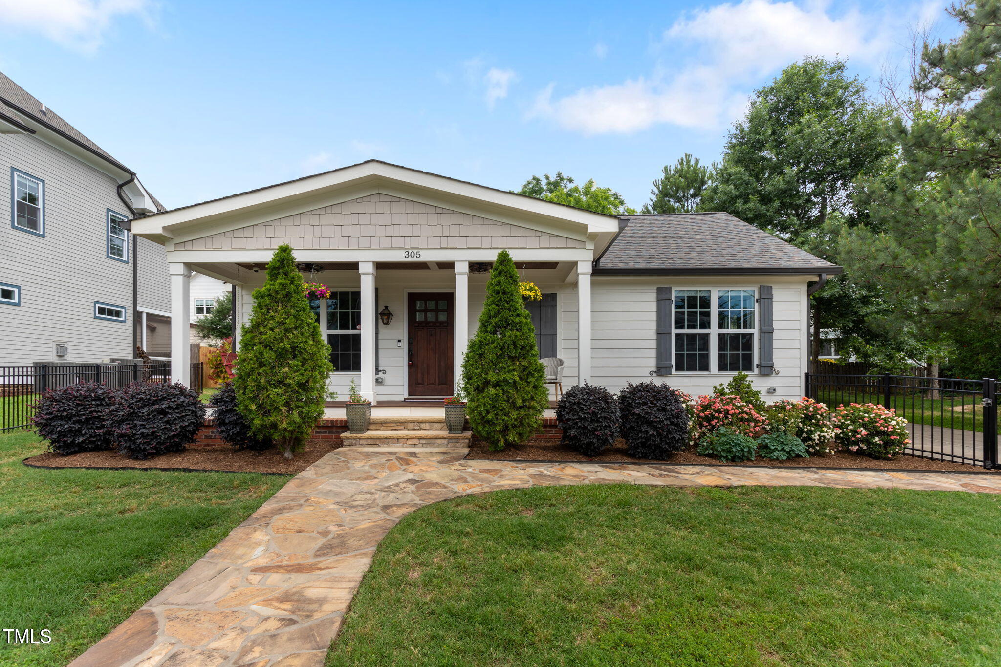 305 Georgetown Road Raleigh, NC 27608 - Photo 1 of 40 a front view of a house with a garden