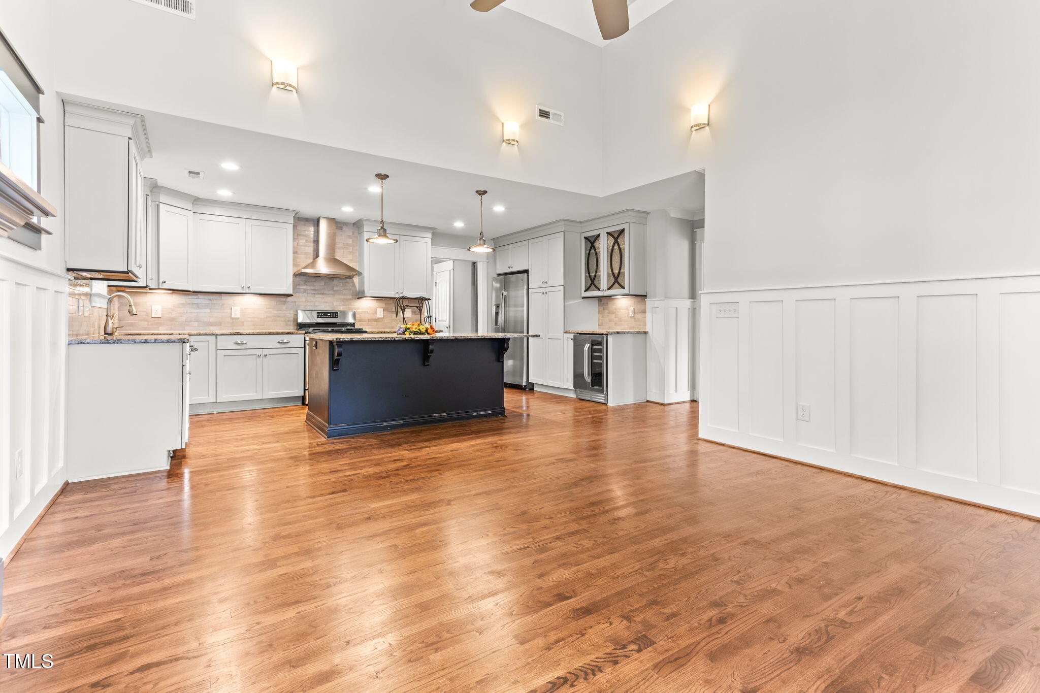 305 Georgetown Road Raleigh, NC 27608 - Photo 12 of 40 a view of kitchen with kitchen island a sink wooden floor and stainless steel appliances