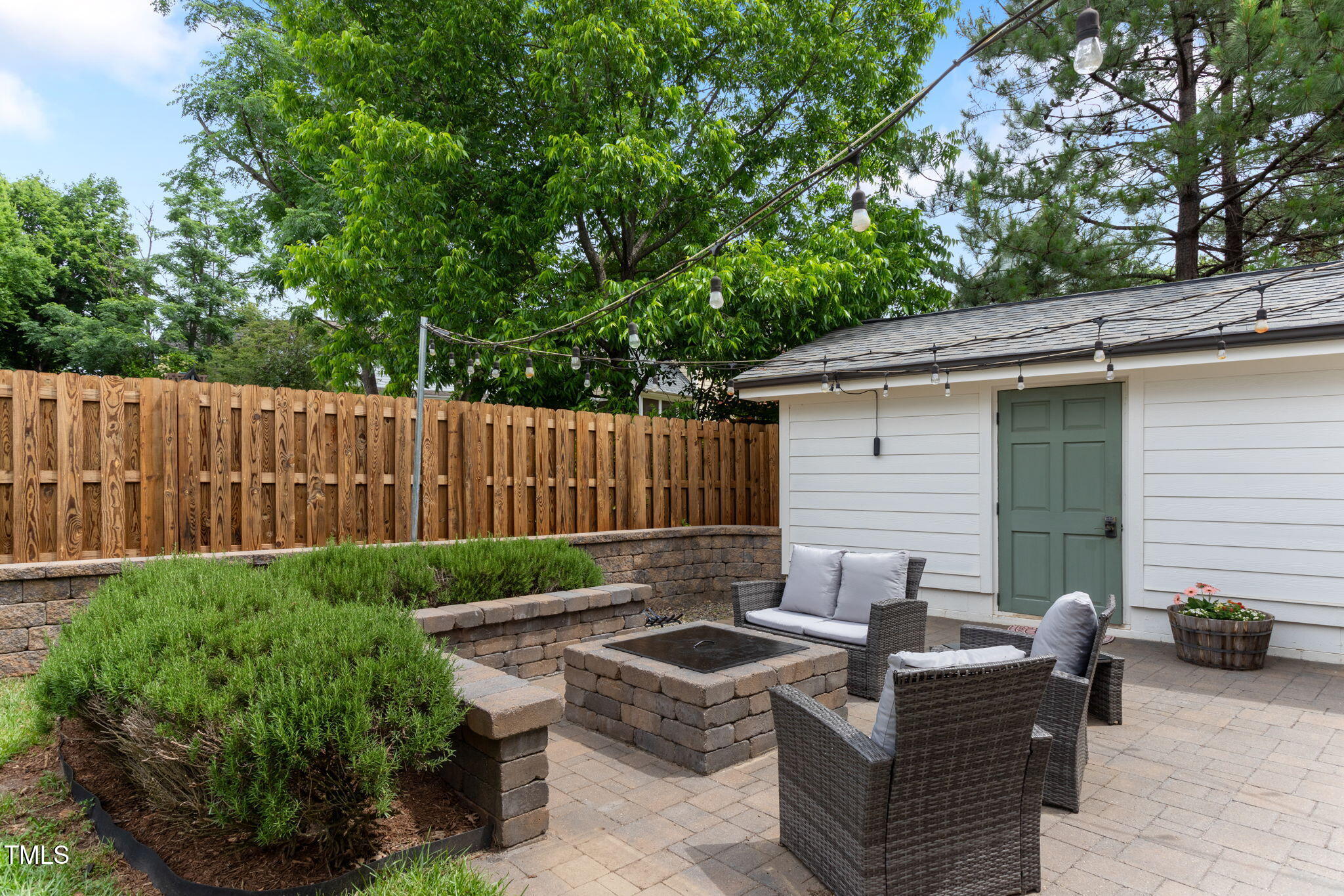 305 Georgetown Road Raleigh, NC 27608 - Photo 37 of 40 a backyard of a house with barbeque oven and outdoor seating