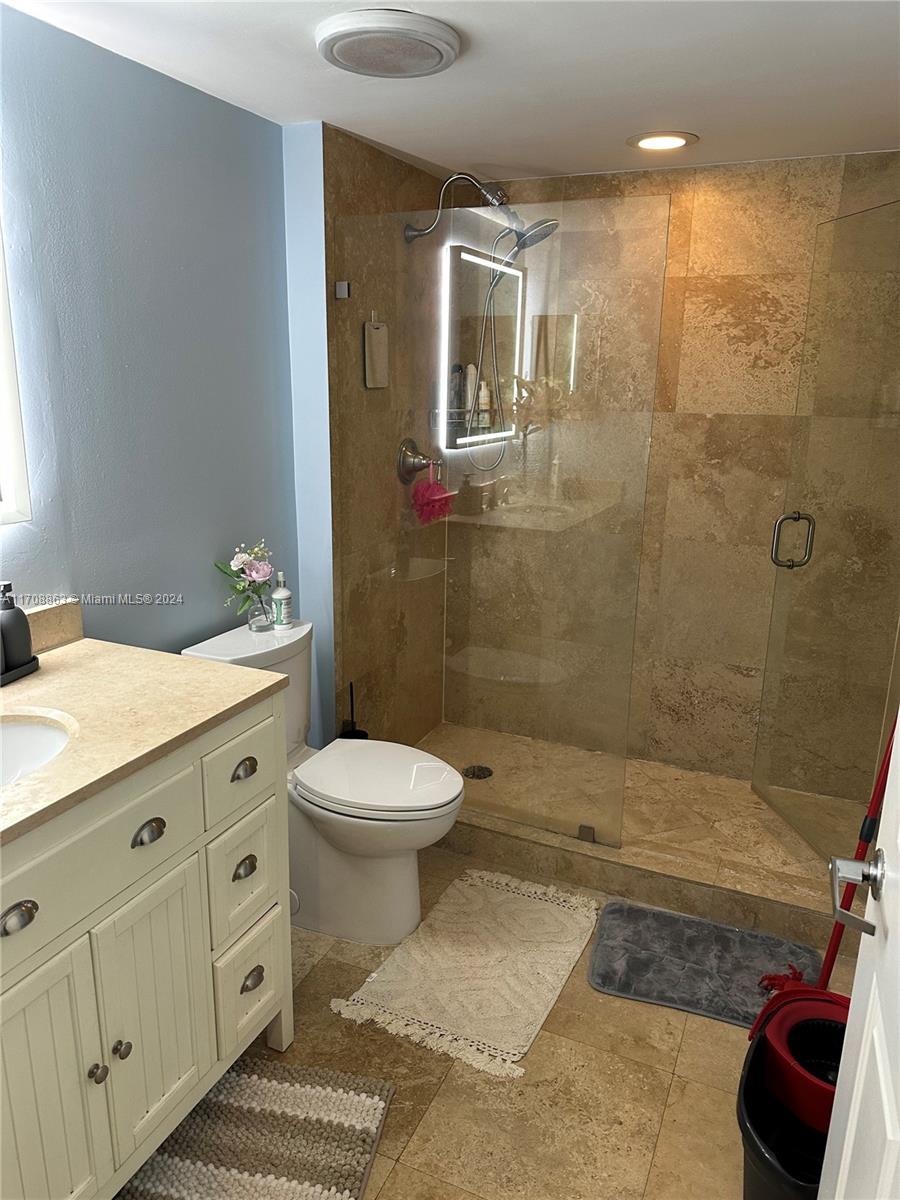 3232 Southwest 22nd Terrace, Unit 1903 Miami, FL 33145 - Photo 12 of 30 a bathroom with a double vanity sink toilet and shower