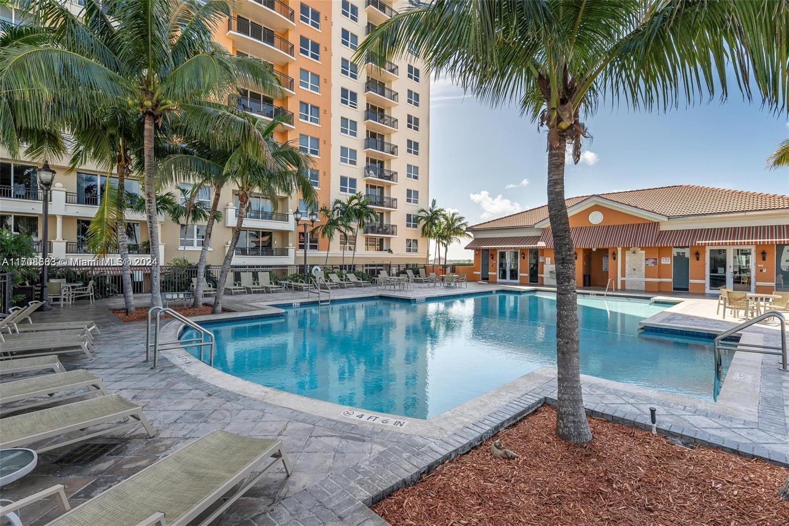 3232 Southwest 22nd Terrace, Unit 1903 Miami, FL 33145 - Photo 22 of 30 a view of a swimming pool with chairs