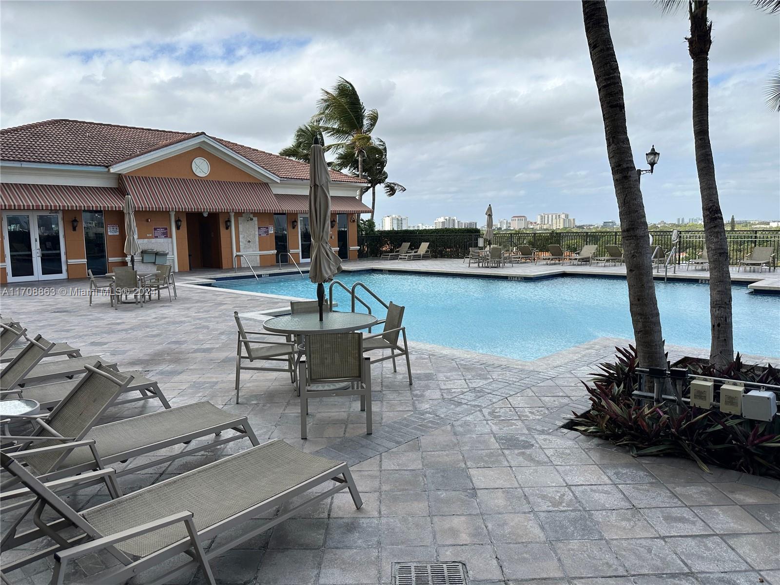 3232 Southwest 22nd Terrace, Unit 1903 Miami, FL 33145 - Photo 28 of 30 a front view of a house with lake view and a floor to ceiling window