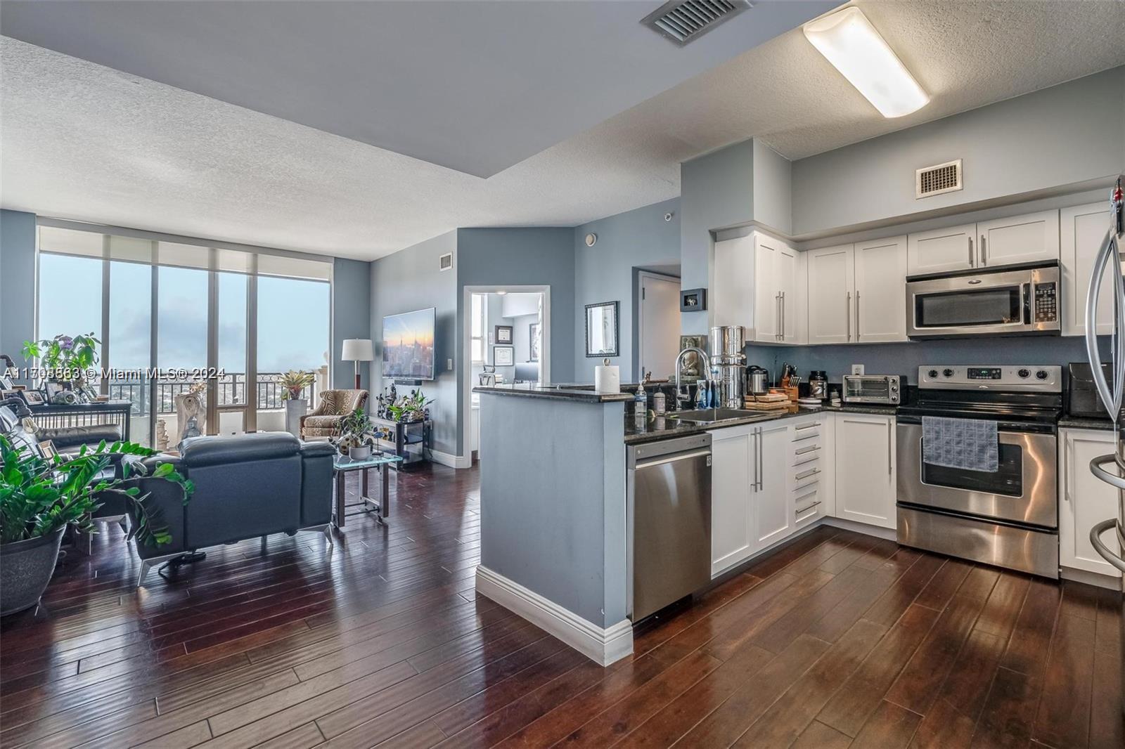 3232 Southwest 22nd Terrace, Unit 1903 Miami, FL 33145 - Photo 4 of 30 a kitchen with a refrigerator and a stove top oven