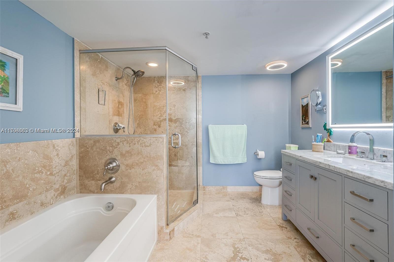 3232 Southwest 22nd Terrace, Unit 1903 Miami, FL 33145 - Photo 10 of 30 a bathroom with a bathtub shower sink mirror and toilet