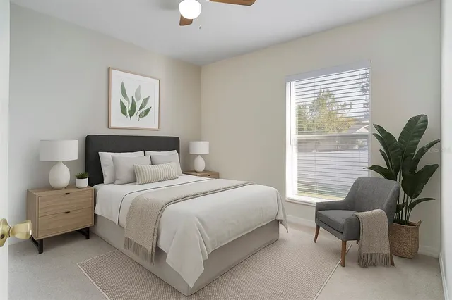 a bedroom with a bed and a potted plant