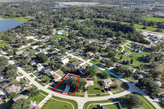 an aerial view of residential houses with outdoor space and swimming pool