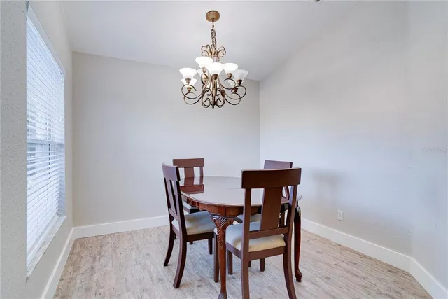 a view of a dining room with furniture wooden floor and a chandelier
