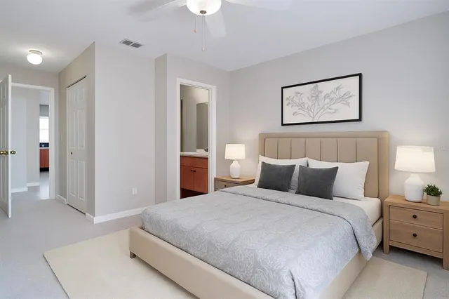 a bedroom with a bed and a night stand