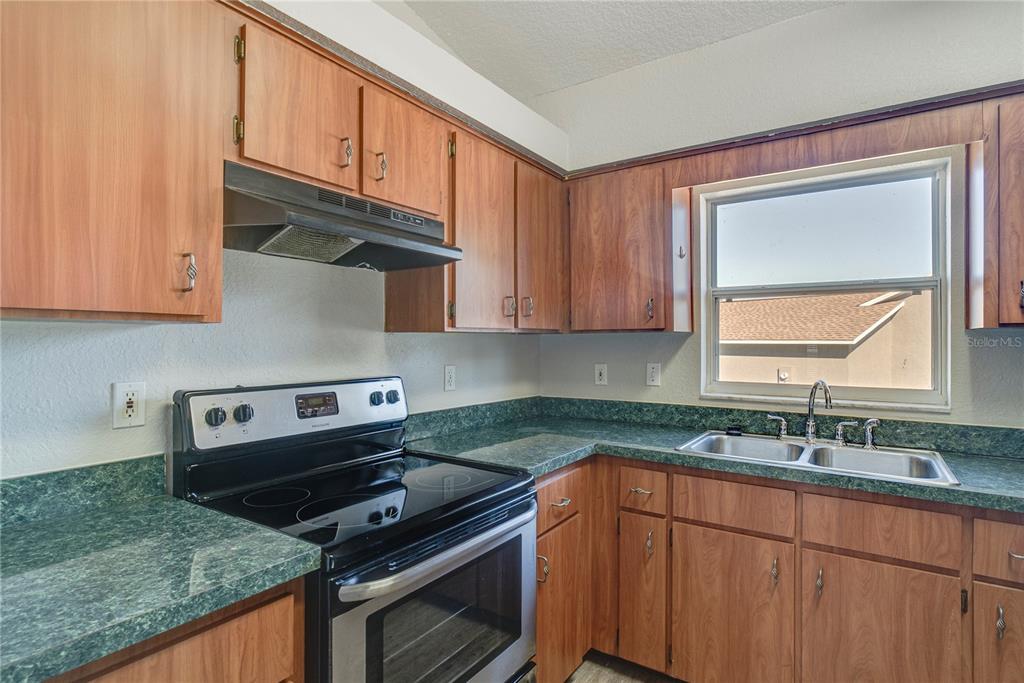 108 Brittany Road Mascotte, FL 34753 - Photo 7 of 23 a kitchen with stainless steel appliances granite countertop a sink stove and cabinets