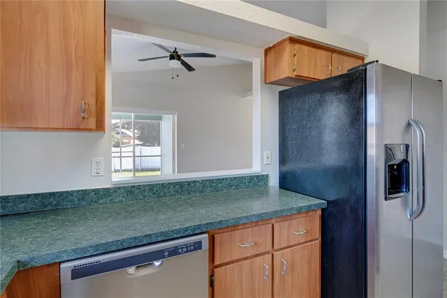 a kitchen with granite countertop a refrigerator and a sink