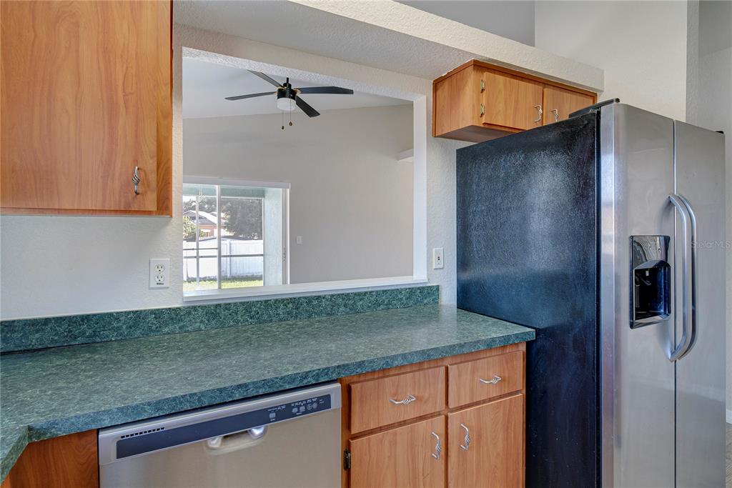 108 Brittany Road Mascotte, FL 34753 - Photo 8 of 23 a kitchen with granite countertop a refrigerator and a sink