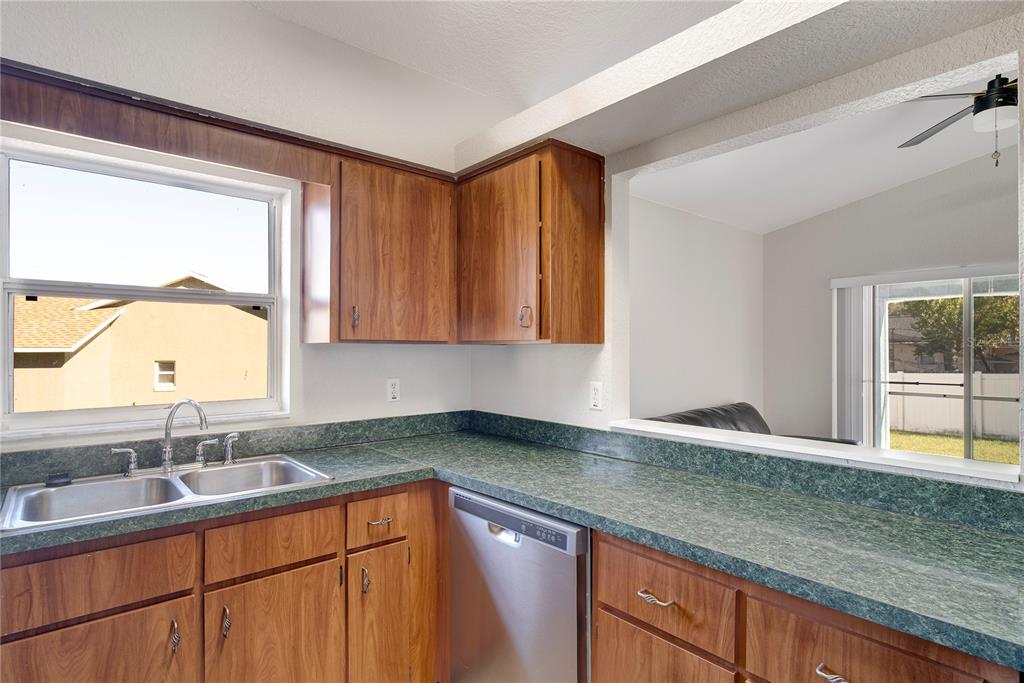 108 Brittany Road Mascotte, FL 34753 - Photo 9 of 23 a kitchen with a sink cabinets and a large window
