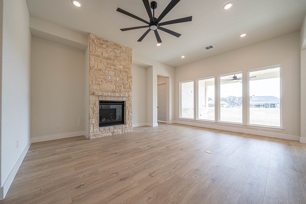 2013 Toscano Way Kerrville, TX 78028 - Photo 5 of 17 a view of an empty room with a window and wooden floor