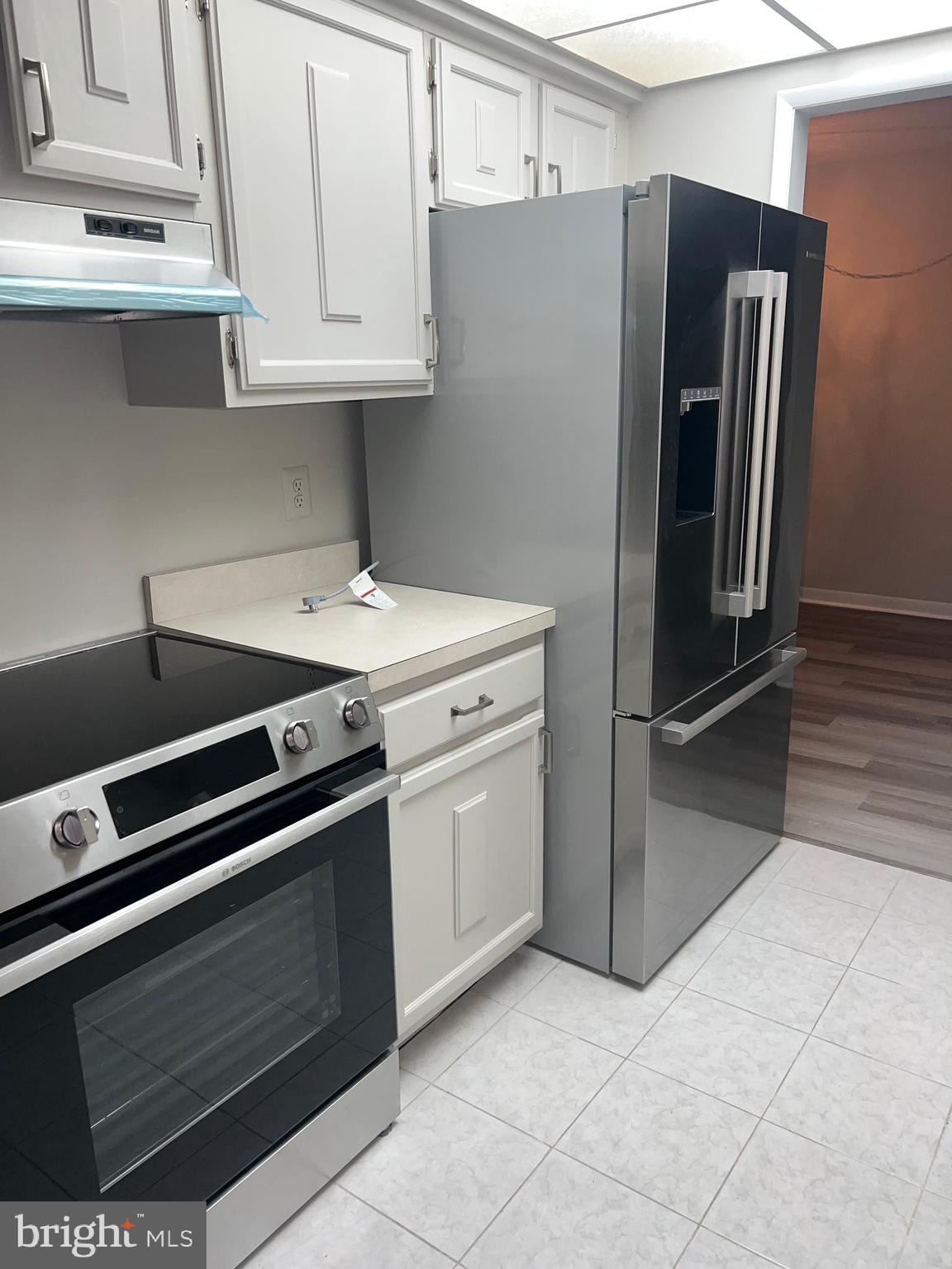 15300 Beaverbrook Court, Unit 882B Silver Spring, MD 20906 - Photo 11 of 44 a kitchen with stainless steel appliances a stove and a refrigerator