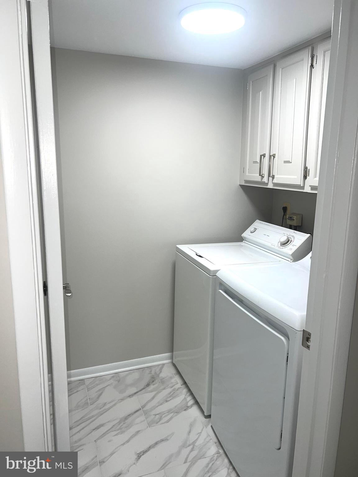15300 Beaverbrook Court, Unit 882B Silver Spring, MD 20906 - Photo 28 of 44 a utility room with dryer and washer