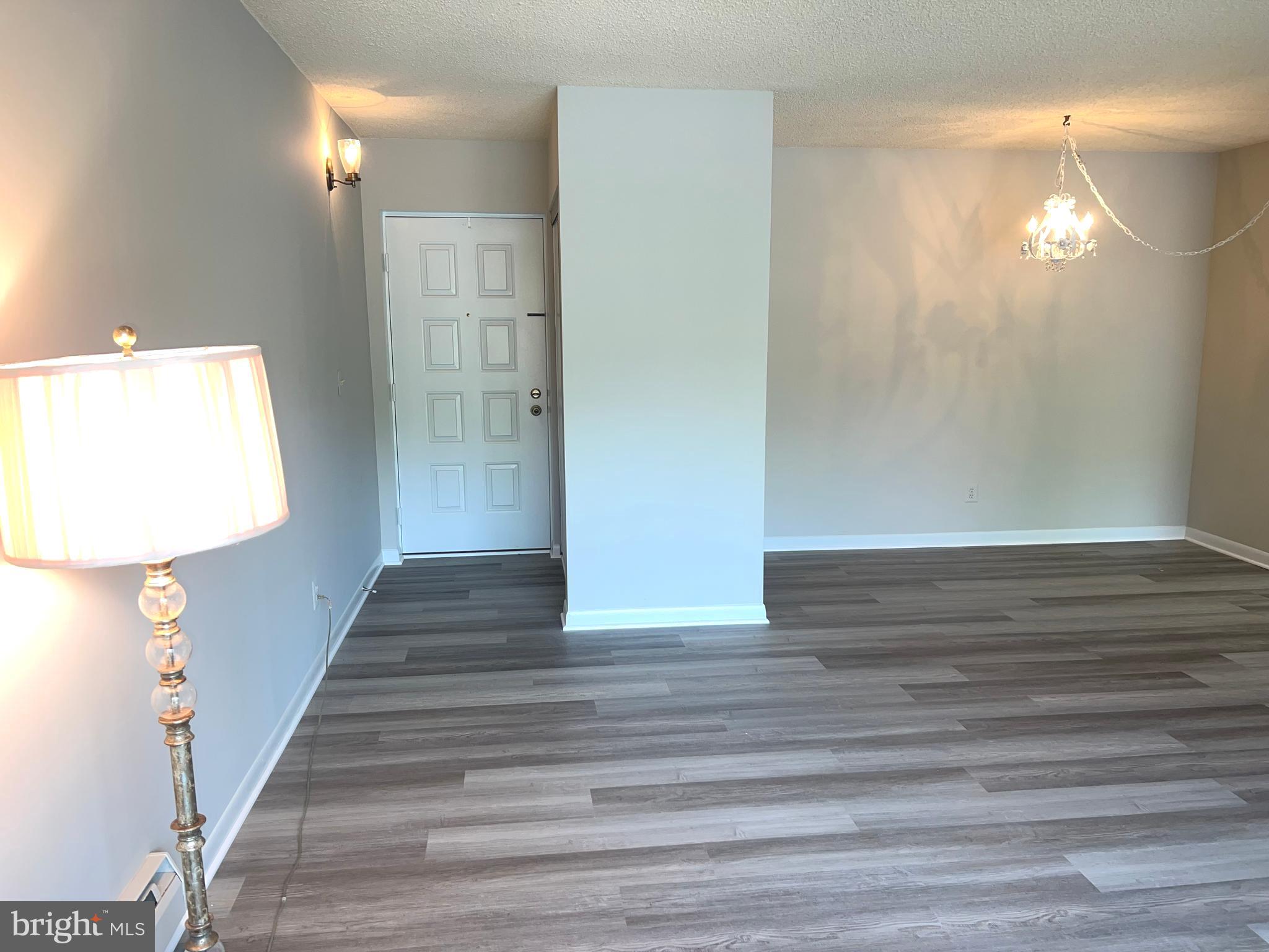 15300 Beaverbrook Court, Unit 882B Silver Spring, MD 20906 - Photo 6 of 44 a view of a hallway with wooden floor and staircase