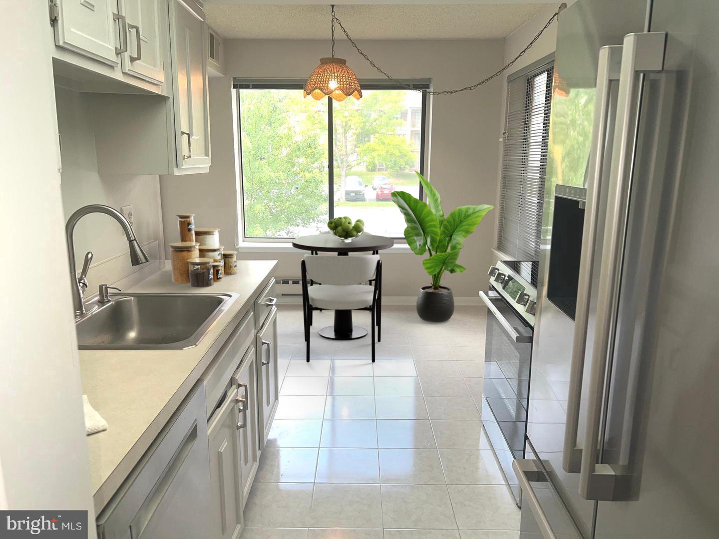 15300 Beaverbrook Court, Unit 882B Silver Spring, MD 20906 - Photo 8 of 44 a kitchen with a sink appliances and a large window