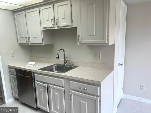 a kitchen with white cabinets and a sink