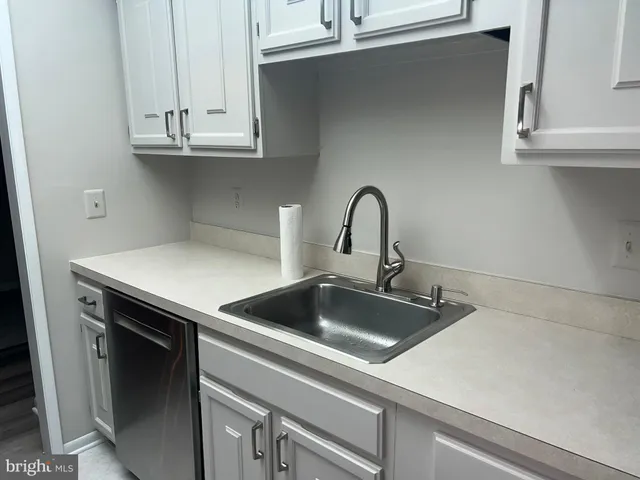 a kitchen with a sink and cabinets