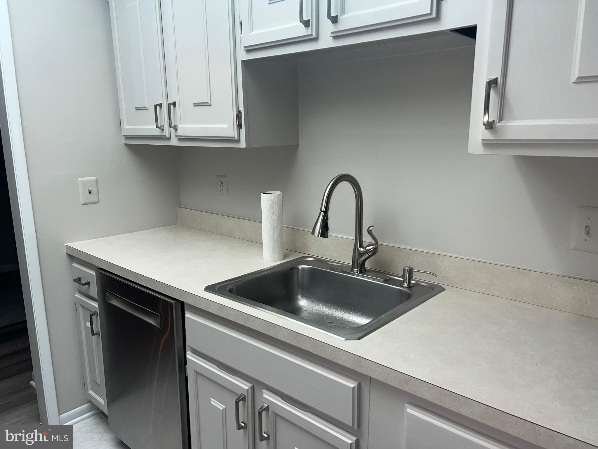 15300 Beaverbrook Court, Unit 882B Silver Spring, MD 20906 - Photo 10 of 44 a kitchen with a sink and cabinets