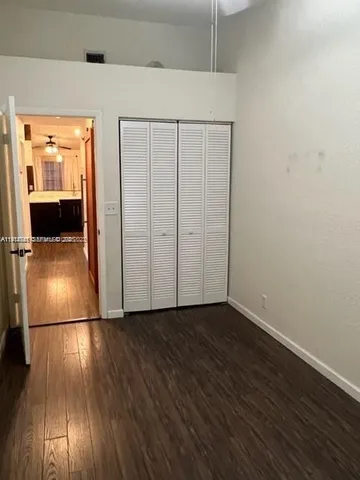 a view of a patio with table and chairs with wooden floor and fence