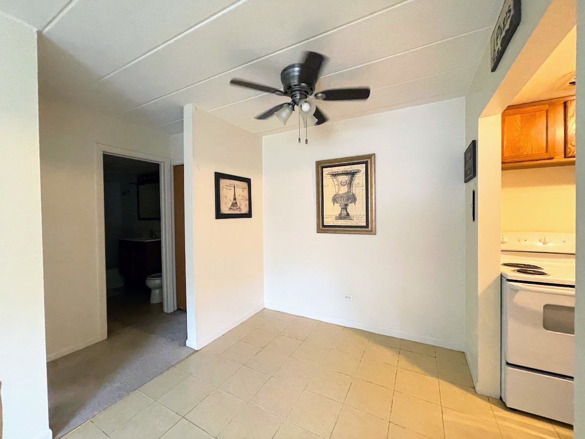 444 Spring Road, Unit 17 Elmhurst, IL 60126 - Photo 7 of 12 a view of a livingroom with a window and a ceiling fan