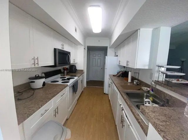 a kitchen with a stove sink and microwave