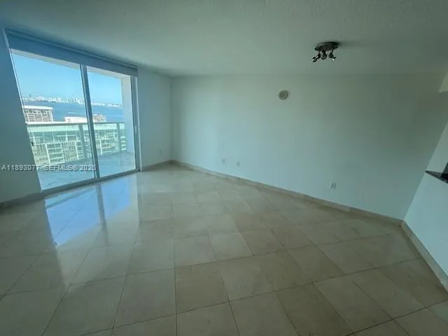 a view of an empty room with glass door