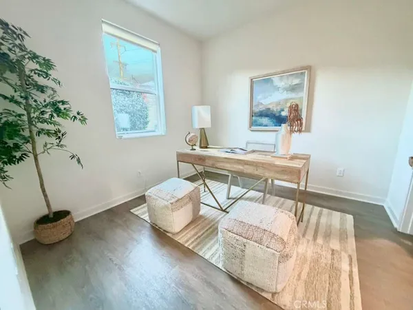 a living room with a couch and a wooden floor
