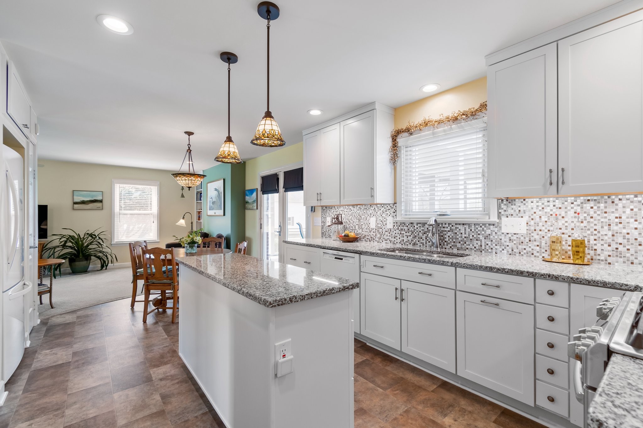 1922 Victorian Road Columbia, TN 38401 - Photo 10 of 25 a kitchen with granite countertop a stove a sink a dining table and chairs
