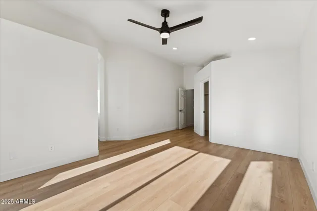 a view of a room with a ceiling fan