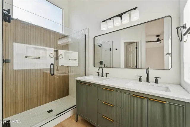 a bathroom with a double vanity sink mirror and