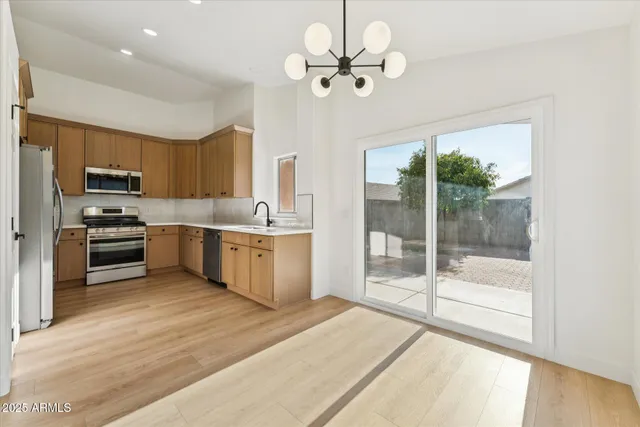 a kitchen with a stove a sink and a refrigerator