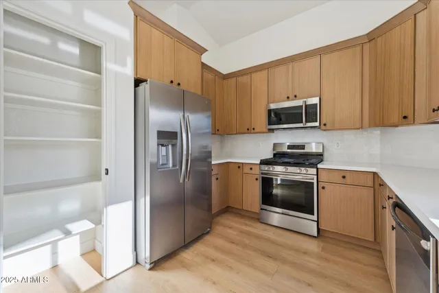 a kitchen with a refrigerator stove and microwave