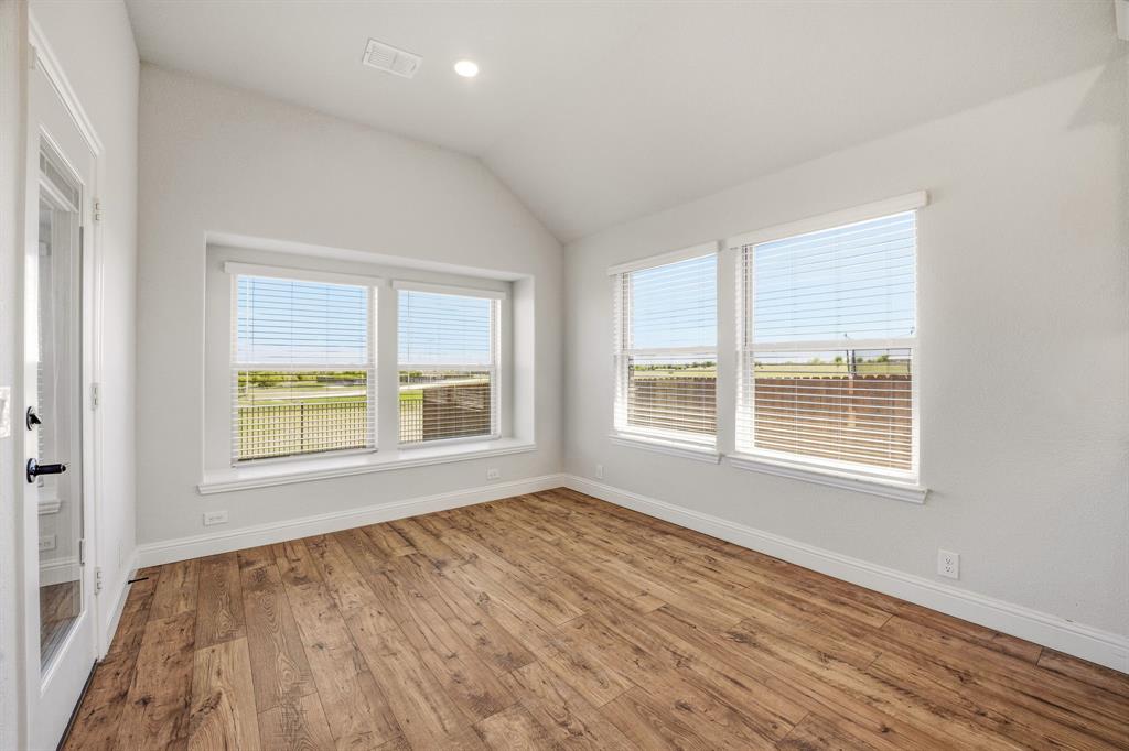 800 Jaguar Ridge Godley, TX 76044 - Photo 11 of 23 a view of an empty room with wooden floor and a window