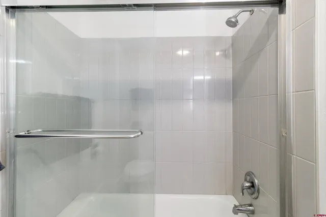 a bathroom with a shower and a sink