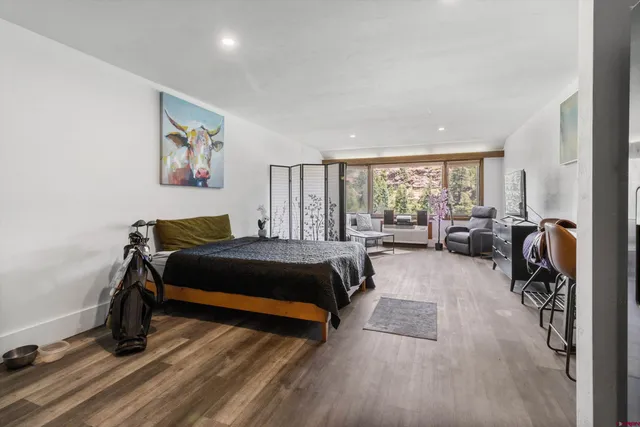 a spacious bedroom with a bed and a large window