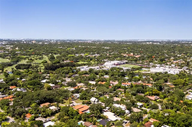 an aerial view of residential houses with city view