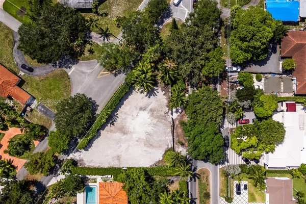 an aerial view of a house with a yard and garden