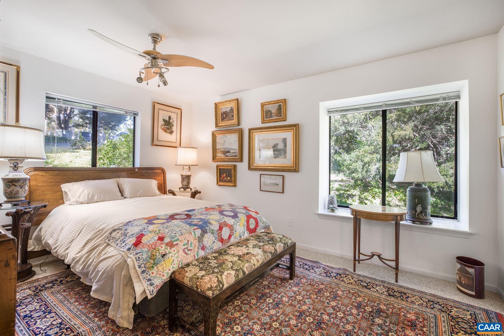 1249 Timberbranch Court Charlottesville, VA 22902 - Photo 15 of 34 a bedroom with a bed a chandelier and a window